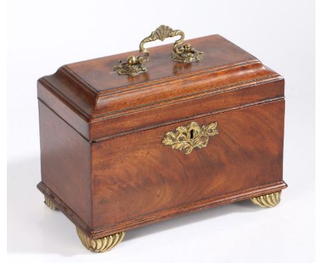 George III mahogany and brass tea caddy, with a shell and scroll handle above the cushion moulded hinged lid enclosing three 