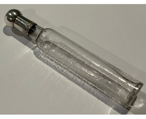 A late 19th century silver mounted clear glass tonic water bottle, Eau Des Carmes Boyer,14 R Taranne, the engraved silver dom