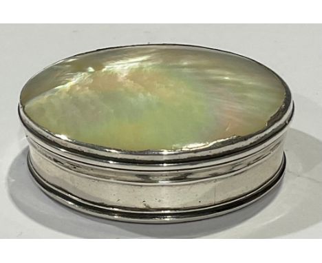 An 18th century silver coloured metal and mother of pearl circular snuff box 