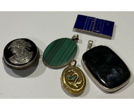 A Victorian 'silver' cameo; two pendants; a Victorian locket; an Art Deco enamel buckle (5) 