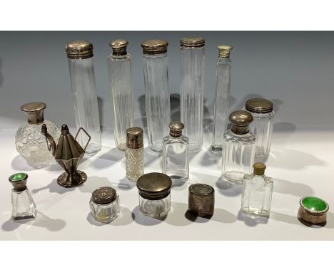 A collection of late 19th century and later glass vanity jars and bottles, some with silver tops, some enamel examples (quant