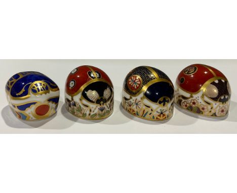 A Royal Crown Derby paperweight, Millennium Bug, gold stopper; others, Four Spot Ladybird, gold stopper; Two Spot Ladybird, g