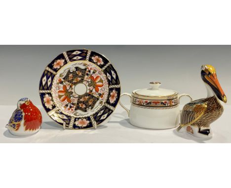 A Royal Crown Derby paperweight, Robin, silver stopper; another, Brown Pelican, silver stopper; a Chardonnay pattern sucrier 