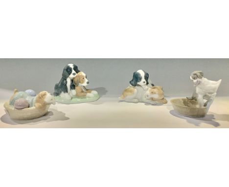 A Nao model group, puppies resting, three others similar (4) 