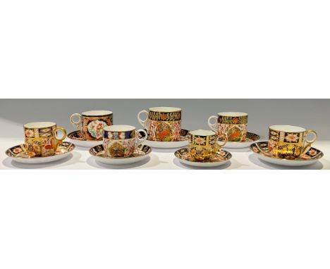 A set of three Royal Crown Derby/Derby Crown Porcelain Company Quail pattern graduated teacups and saucers, number 861, vario