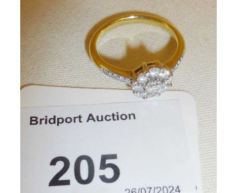 18ct gold diamond cluster ring marked as 750. Approx UK size P and weight 4.5g