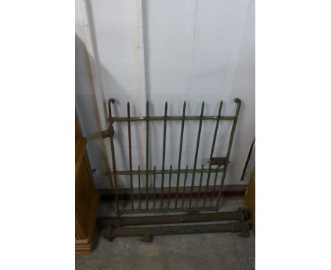A wrought iron gate with posts