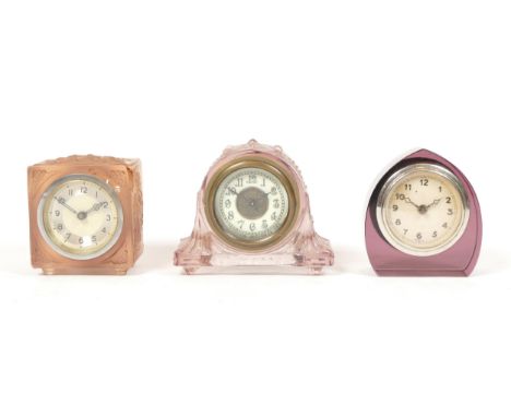 A 1930s Art Deco moulded glass desk clock by Anso U.S.A, having porcelain dial with Arabic numerals, 9cm tall, together with 