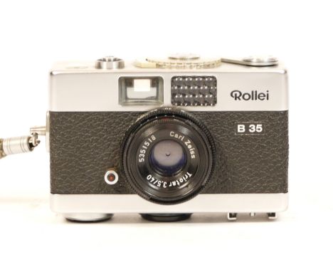 A Rollei B35 camera, in chrome, with case and wrist strap