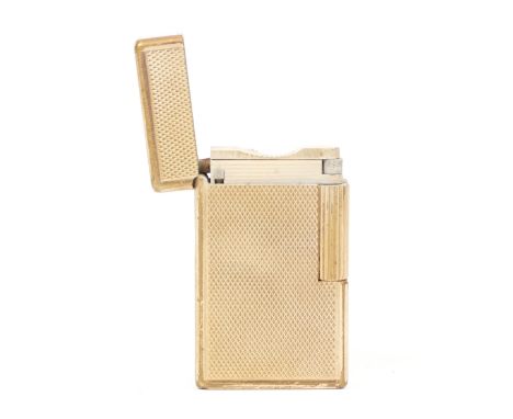 S.T. Dupont; A gents gas pocket cigarette lighter, gold tone with hobnail pattern. In used condition, showing one ding to the