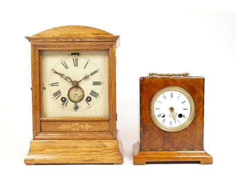 An early 20th century oak cased mantel clock, the manual wind movement incorporating an alarm, striking on bell, 29cm tall, t