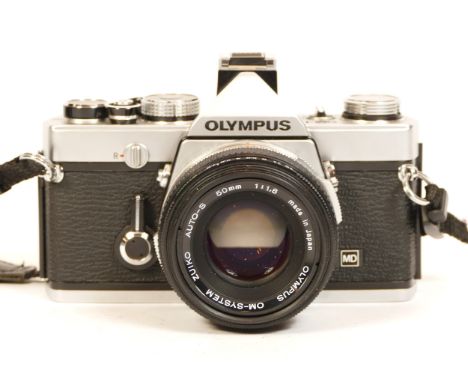 An Olympus OM-1n SLR camera, chrome finish, with 50mm f/1.8 Zuiko lens