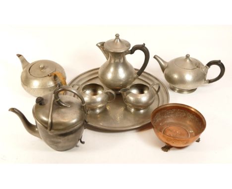 A hammered pewter tea service, stamped Tudric 1921, on the base, together with a James Dixon Sheffield pewter teapot, with in