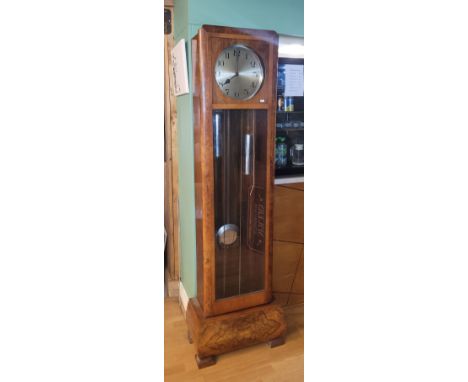 A mid 20th century mahogany and walnut longcase clock, the full length glazed door enclosing a silvered dial with Arabic nume