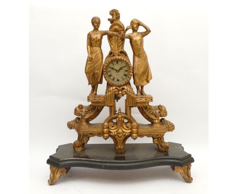 A twentieth century figural mantel clock, mounted in gilt wood with a tin dial and Roman numerals, housing a thirty-one day m
