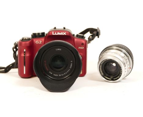 A Panasonic Lumix G2 camera, with 14-42mm lens, along with various M4/3 adaptors including one with a Steinheil Culmigon 35mm