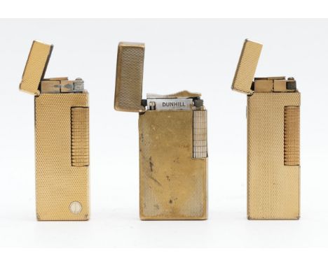 Alfred Dunhill; Two Dunhill gold plated rollagas cigarette lighters, having engine turned cases, together with a Dunhill 70 c