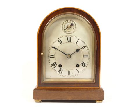 A mahogany cased bracket clock with a boxwood inlaid trim, a silvered dial and chapter ring featuring Roman Numerals and a su