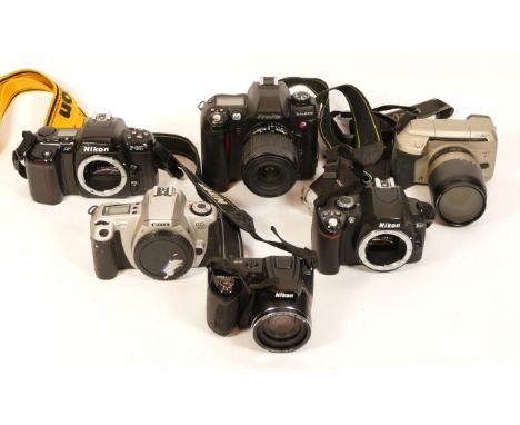 A collection of cameras, including Fujifilm Finepix S2 Pro DSLR, Nikon D40, F601, Canon EOS 300, Minolta Vectis S1, Nikon Coo