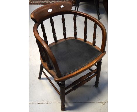 A late 19th early 20th century oak captains style chair with ring turned supports and black leather seat.