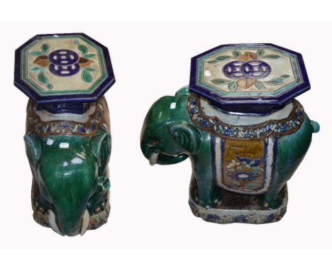 A pair of early 20th century ceramic elephants, jade green ground with royal blue, jade and turquoise octagonal seat to the t