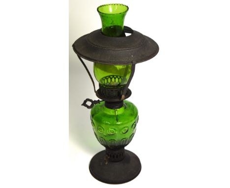 A green glass oil lamp with metal base and shade, height 41cm.
