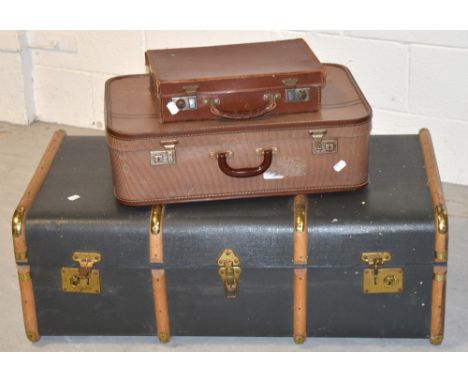 A 20th century blue wooden strap bound trunk with brass fittings and two vintage suitcases to include a small leather example
