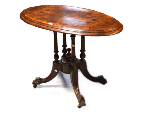 A Victorian walnut loo table of small proportions, raised on four ring turned supports on central quadripartite base, termina