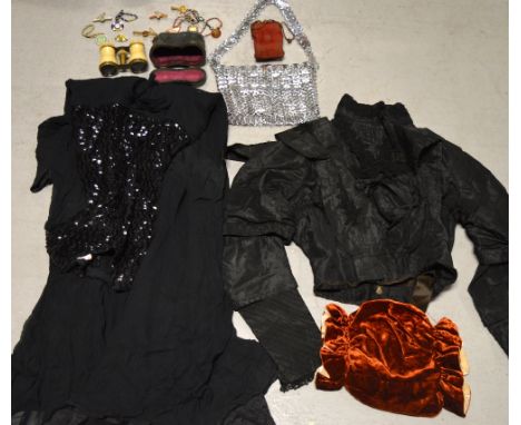 A mixed lot to include a velvet muff, a c.1960s black chiffon sequinned dress, a Victorian black fitted lace and silk jacket,