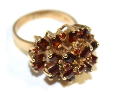 A 9ct gold cluster ring set with red stones, size M, approx 7.2g.