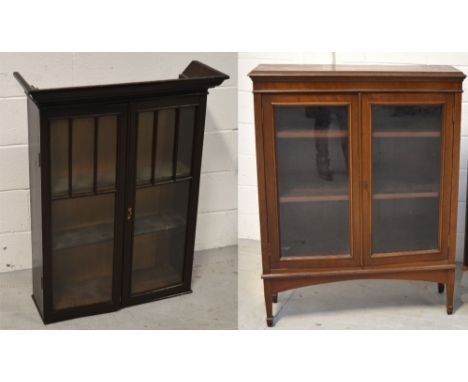 A small bookcase, the top shelf above two glazed doors also a mahogany bookcase, with two glazed doors and two interior shelv