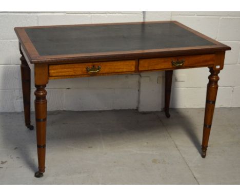 A late 19th century mahogany black leather inset desk with two short drawers above ring turned legs and castors, width 122cm.