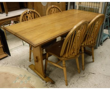 A modern oak refectory style kitchen table and a set of four stained beech wheel and stick back chairs