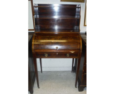 An Edwardian mahogany and inlaid bureau de dame, the three shelf superstructure over a cylinder top writing compartment and s