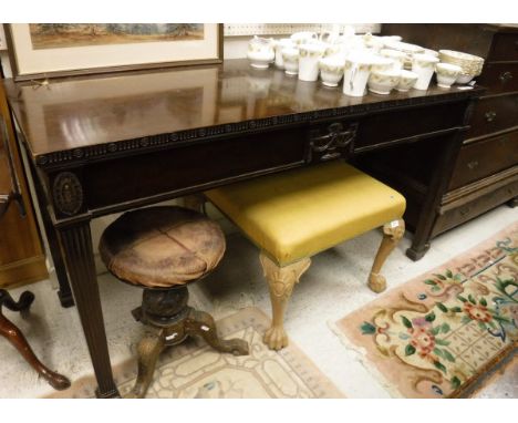 A circa 1900 mahogany serving table in the Adam taste, the plain top with carved edge over a plain frieze with central urn pa