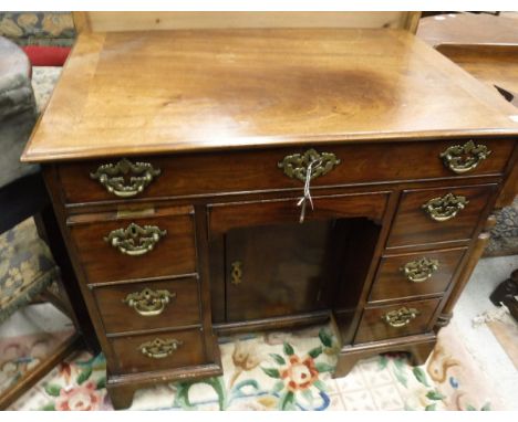 A Victorian mahogany dressing table, the rising top opening to reveal a fitted interior over a dummy drawer and small drawer 