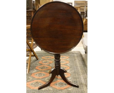 A 19th Century mahogany tea table, the circular snap top on a turned pedestal to splayed tripod base