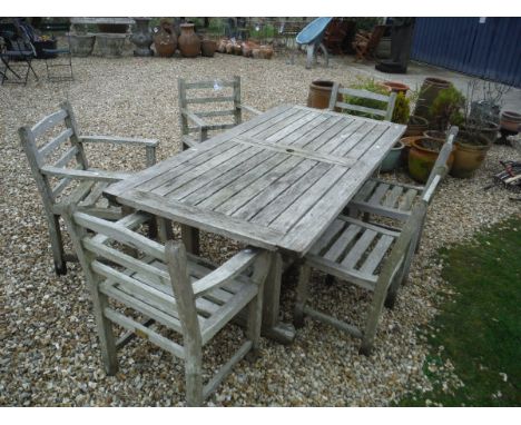 A teak slatted garden table and six chairs (four plus two) CONDITION REPORTS All items are very weathered and greyed.  moss g