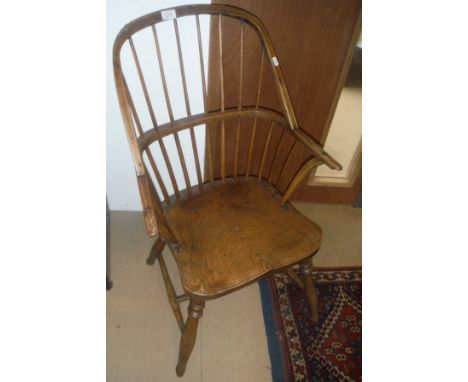 A 19th Century ash and elm stick back elbow chair on turned legs united by an H stretcher