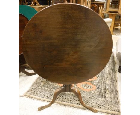 A 19th Century mahogany tea table, the circular snap top on a turned pedestal to cabriole tripod base