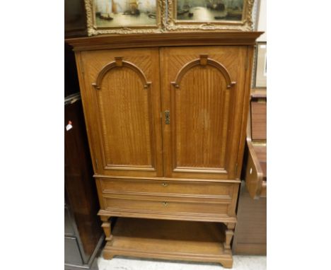 A circa 1900 satinwood cabinet, the two cupboard doors enclosing various shelves and filing drawers bearing paper labels insc