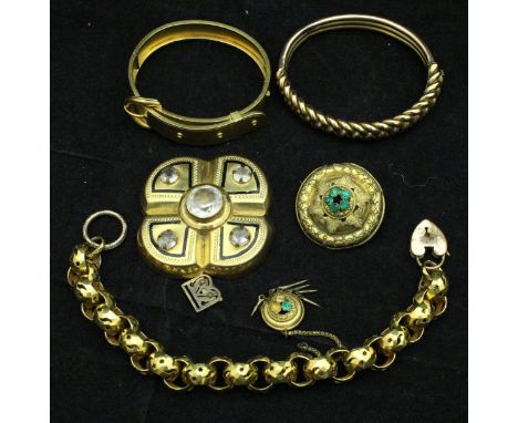 A collection of gold coloured jewellery including a "belt" bracelet, a chain link bracelet, star hoop bracelet, paste set buc