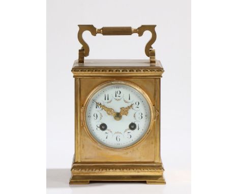 Late 19th Century French brass carriage clock the case with reeded swing handle, the white enamel dial with Arabic numerals a