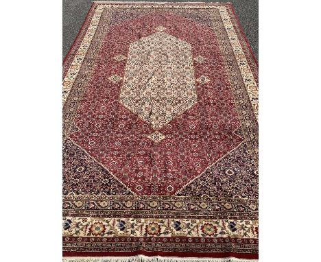 LARGE PERSIAN WOOLLEN CARPET of red ground, floral and abstract pattern throughout, 615 x 330cmsProvenance: private collectio