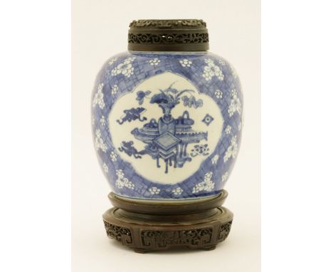 A Chinese blue and white ginger jar,Kangxi (1662-1722), painted with incense burners, vases, books and other precious objects