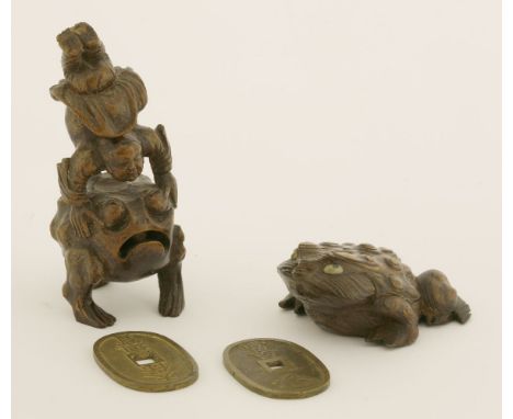 A Japanese bamboo Gama Sennin,19th century, carved with the immortal doing a handstand on the back of the three-legged toad,1