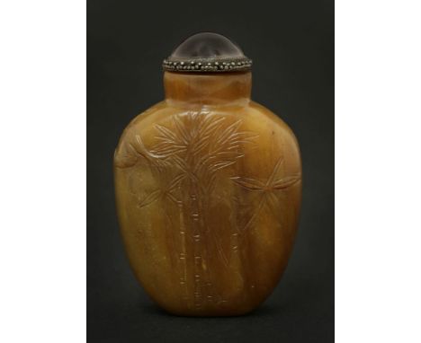 A Chinese jade snuff bottle, 20th century, carved with a deer looking up to a bird in a pine tree, the reverse with bamboo, a