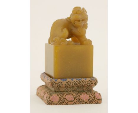 A Chinese soapstone seal, 20th century, carved with a mythical beast seated on a square pedestal, inscription engraved to one