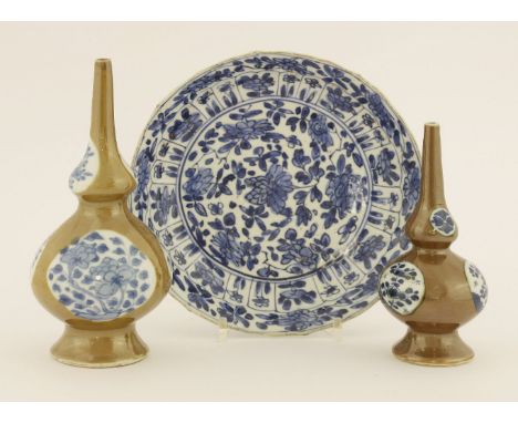 A Chinese blue and white dish,Kangxi (1662-1722), of shaped circular form, painted in Kraak style with flowers, the base with