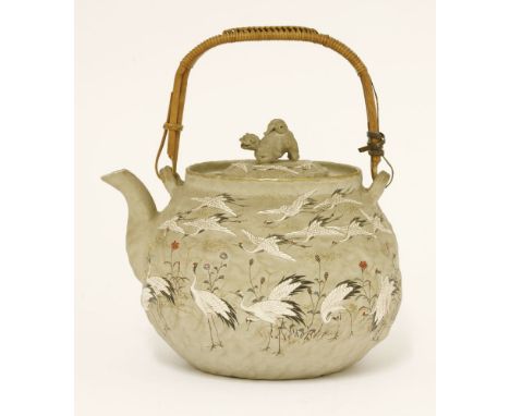 A Japanese stoneware teapot, late 19th century, with numerous cranes and flowers, Buddhist lion knop, signed, 11.5cm to top o